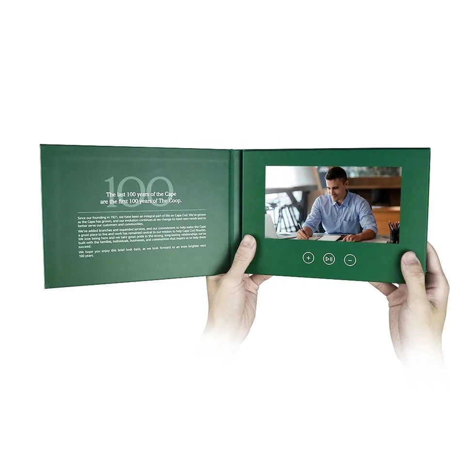 Person holding green video brochure booklet.- M&M Tech